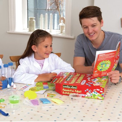 A little boy playing with Horrible Science Frightful First Experiment Kit.
