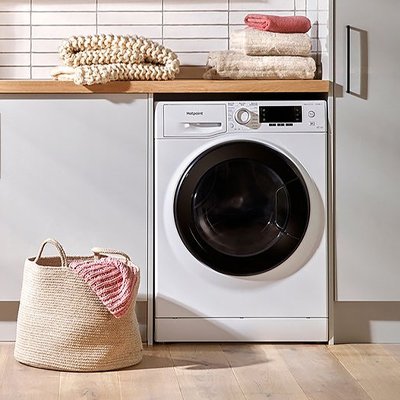 Hotpoint NDD86448WDAUK 8kg/6kg 1400 Spin Washer Dryer in white colour in a laundry room.