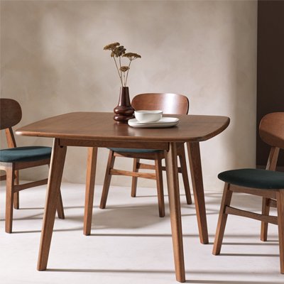 Wooden dinning table with matching chairs with black cushion pads inspired by mid century furniture trend.