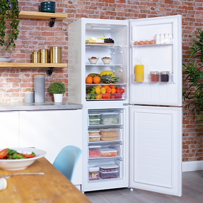 A white freestanding fridge freezer placed in a kitchen.