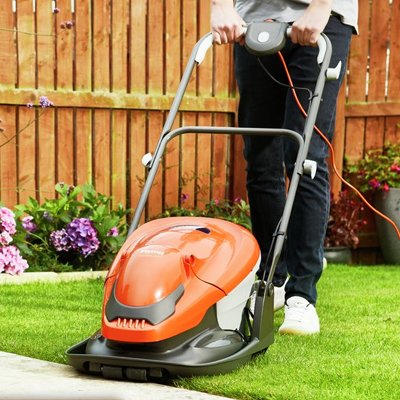 Lawn mower mowing garden lawn.