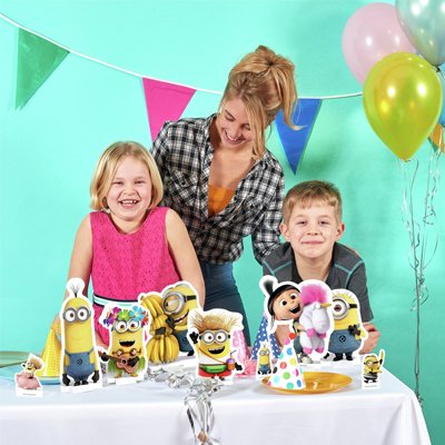 Kids celebrating their birthday with mum in a room decorated with Minions theme party decorations.