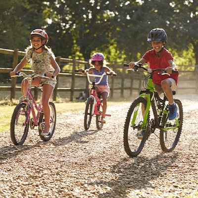A group of kids riding their bikes outdoors.