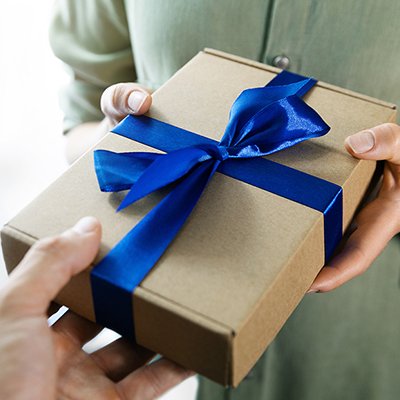 A woman gifting her partner a present.