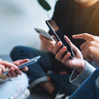 A group of people having a discussion over mobile phones.