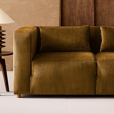 Brown velvet made to order sofa in living room with wooden accents.