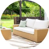 Garden chairs with white cushions in garden.