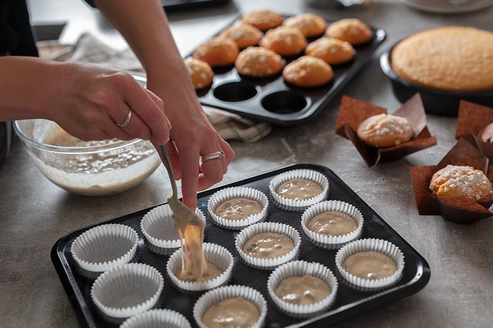 A baker preparing to cook buns.