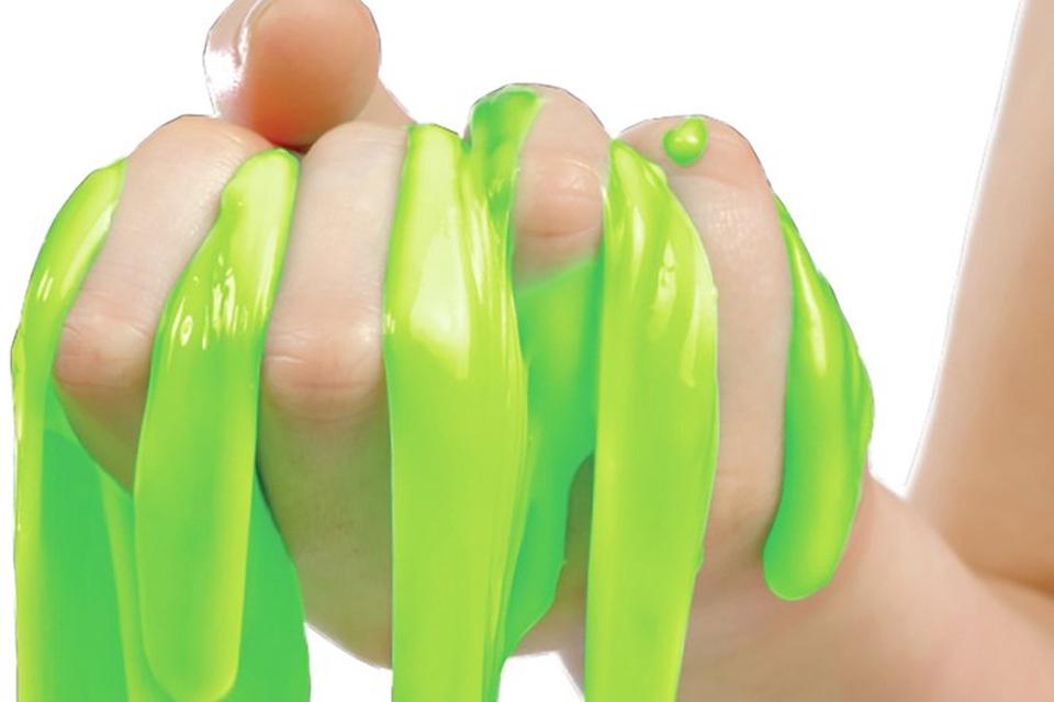 A child's handful of neon green slime.