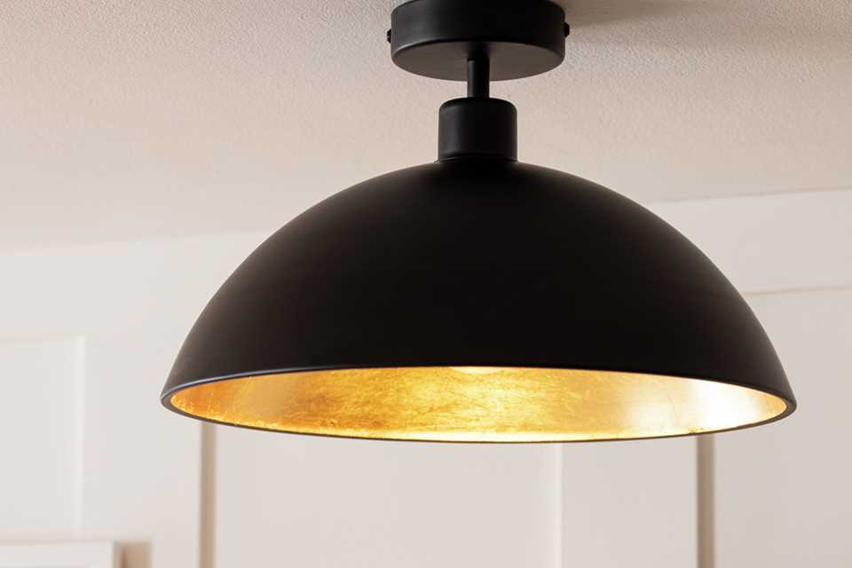 Flush to ceiling light  in matt black with gold  interior.