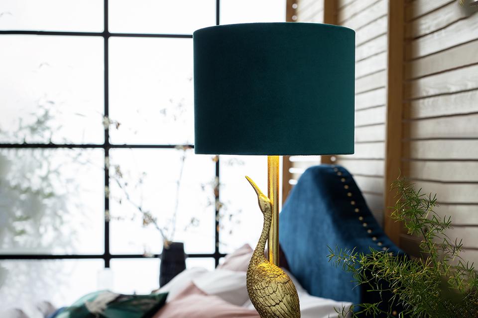 Elegant and regal crane lamp crafted in rich gold resin.