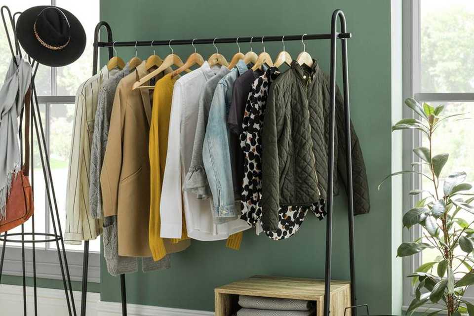 Image of a clothes rail and shoe storage unit in a bedroom.