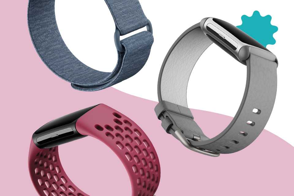 Three Fitbit smartwatches with colourful straps.