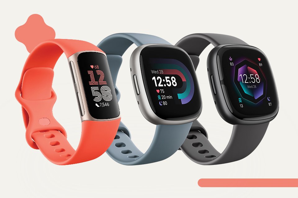 Two Fitbit smartwatches and a fitbit fitness tracker with colourful starps.