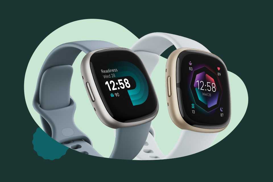 Two Fitbit smartwatches with blue and white straps.