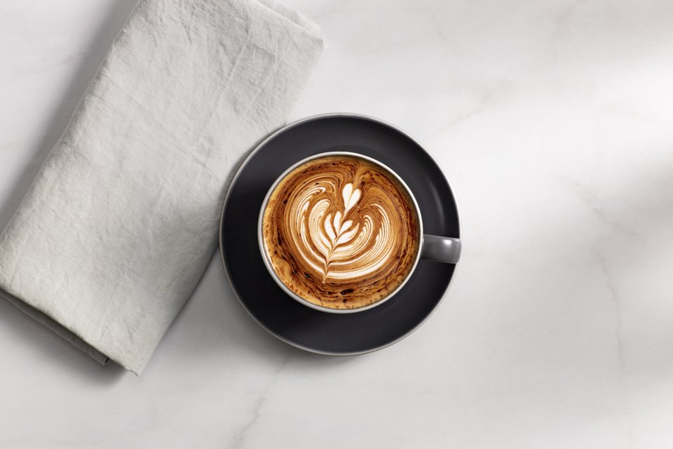 A coffee cup placed on a white table.