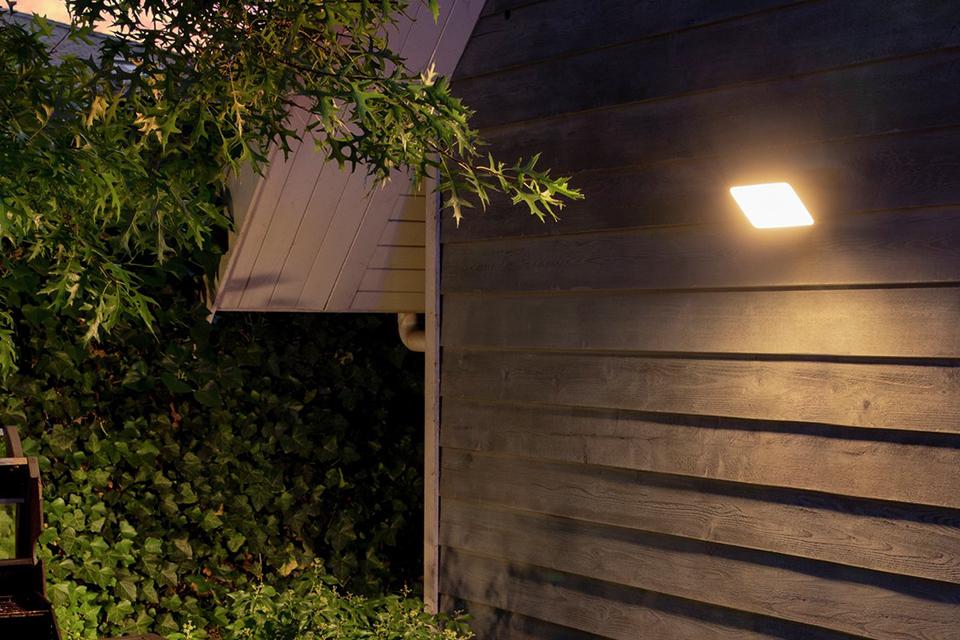 Outdoor floodlight attached to the back of a shed.
