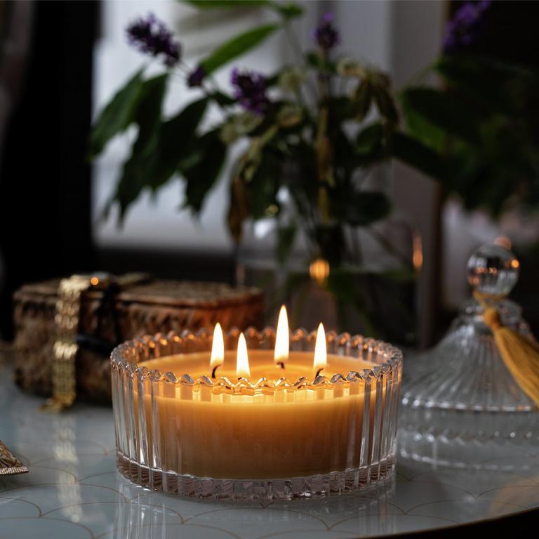 Image of a yellow, 4-wick candles in a glass pot.