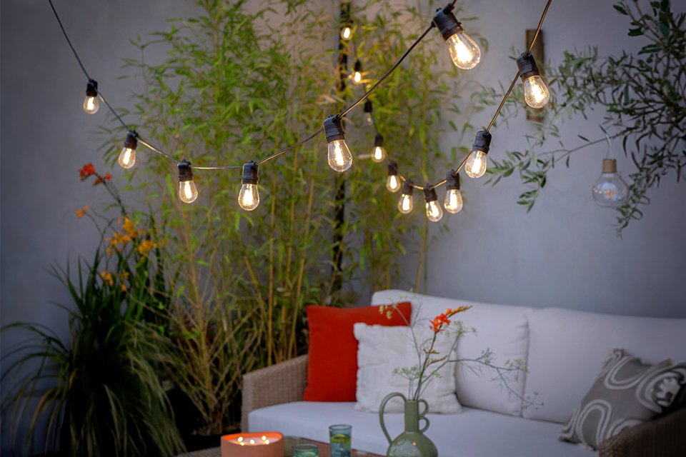 Outdoor string lights hanging above garden.