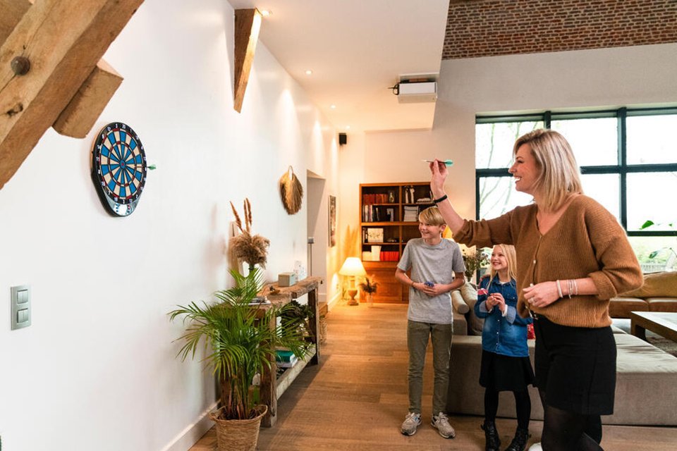 A family playing darts on Decathlon ED110 Electronic Dartboard.