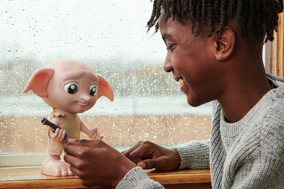 A boy playing with Wizarding World Harry Potter Interactive Dobby.