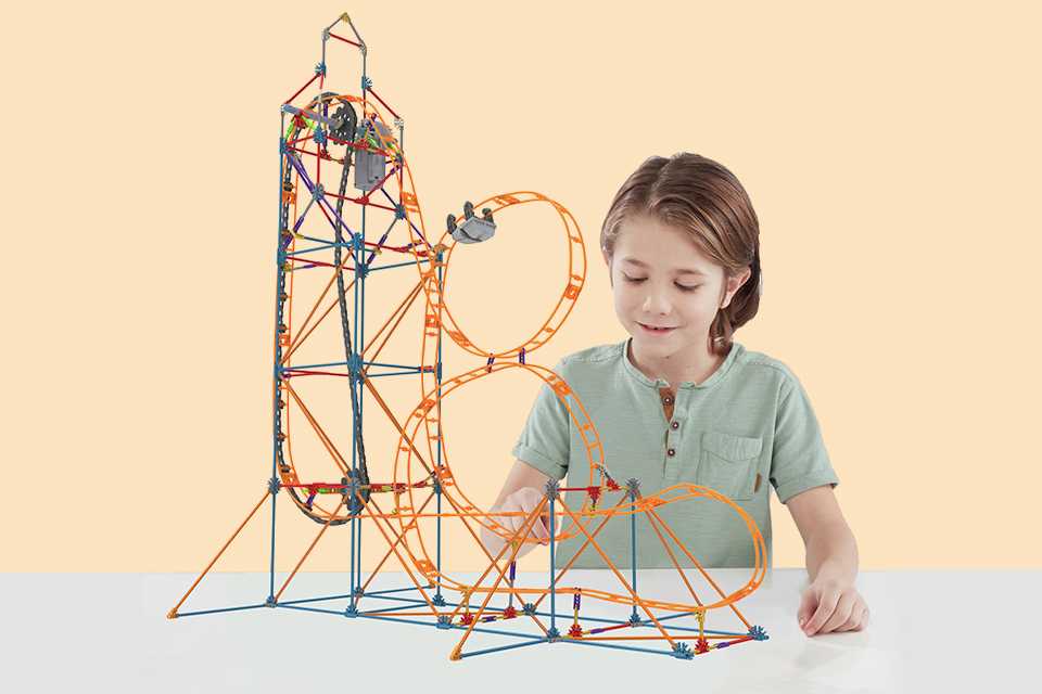 A girl building the K'NEX Amazing 8 Roller Coaster STEM toy.