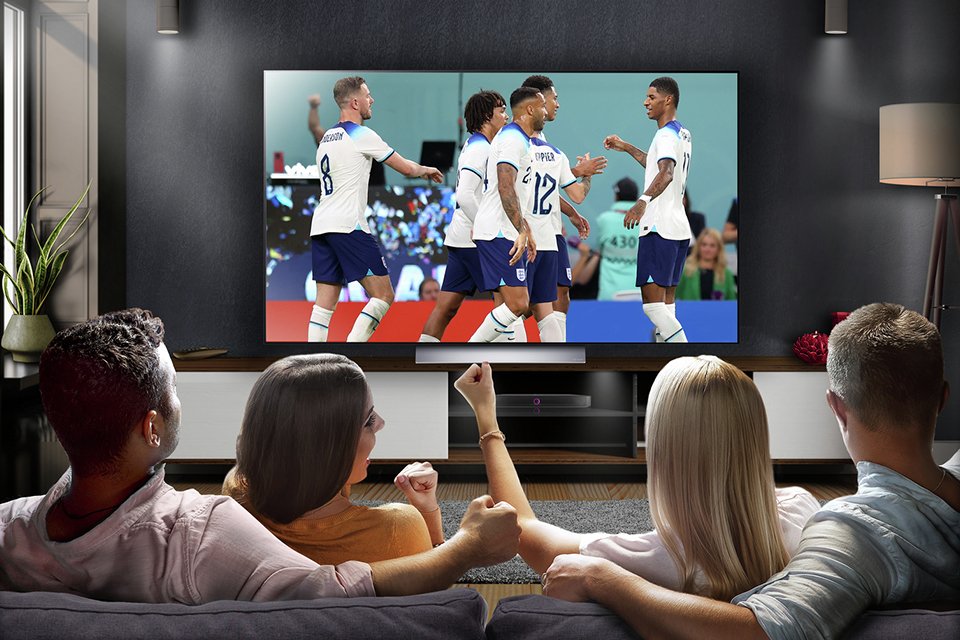 A group of friends watching sports on a TV.
