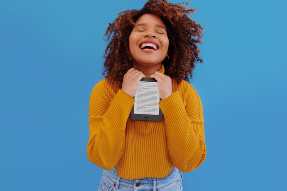 A smiling woman holding a Rakuten Kobo eReader.