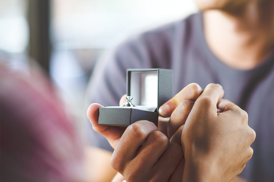A man proposing with a Revere white gold and diamond engagement ring.