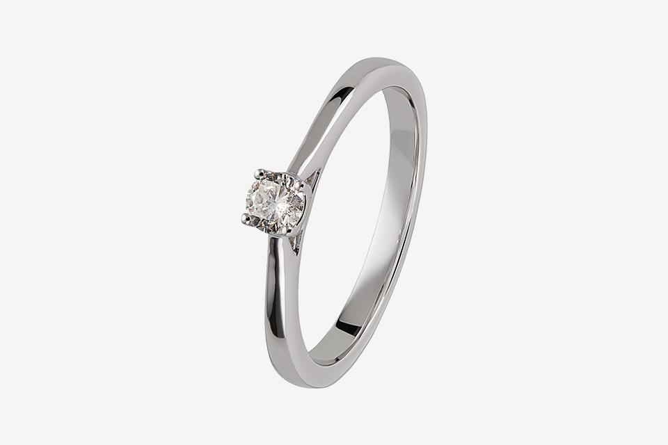 A platinum diamond ring with a white background.