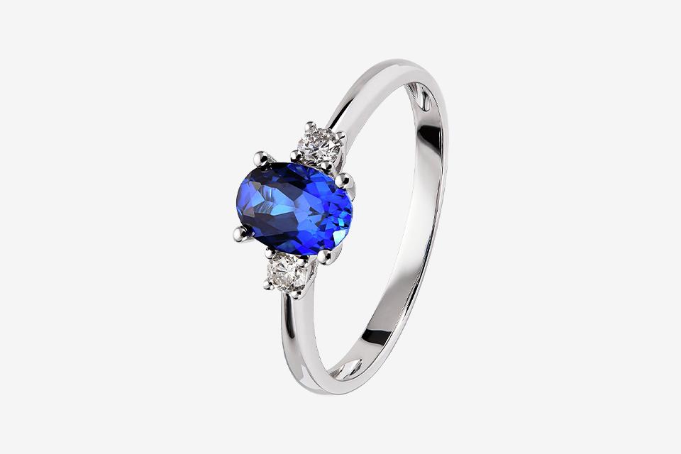 A white gold diamond ring featuring blue sapphires.