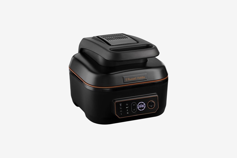 A black Russell Hobbs Air & Grill multicooker with copper accents.