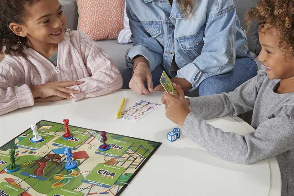Kids playing a board game with their mum.