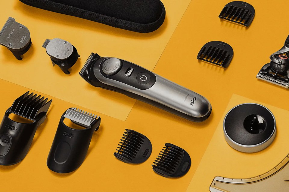 Different parts of a Braun trimmer spread on a yellow floor.