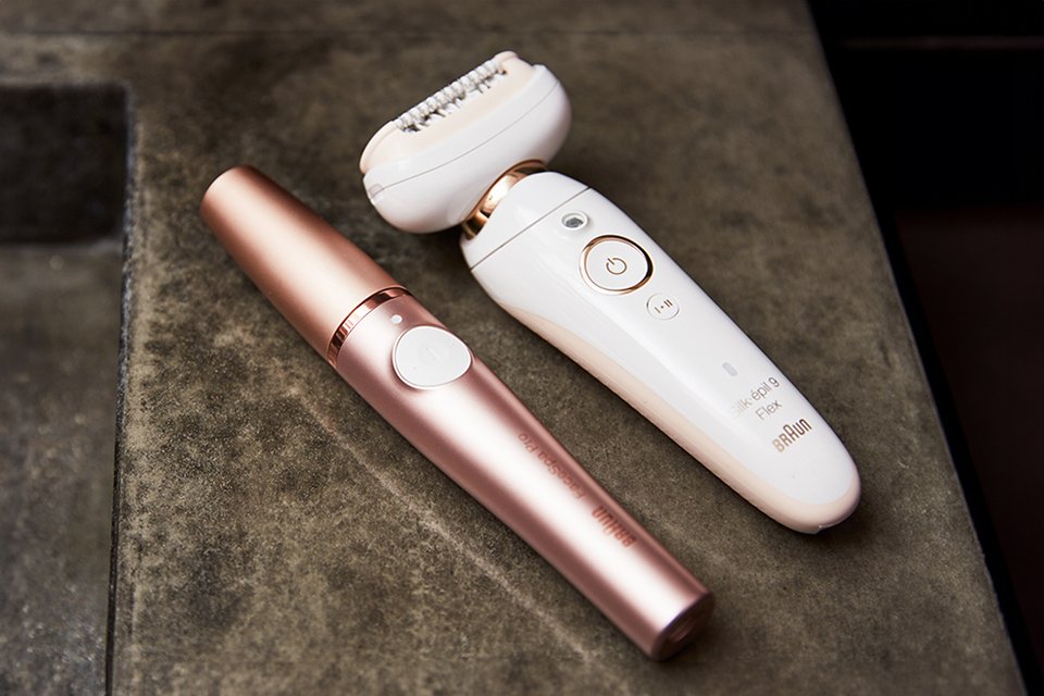 Braun's epilator devices placed next to each other on a marble slab.