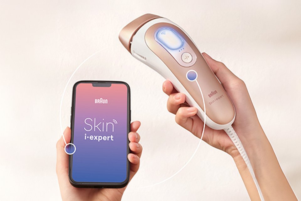 Braun Skin i-expert Corded IPL Hair Removal device shown connected to a mobile phone app.