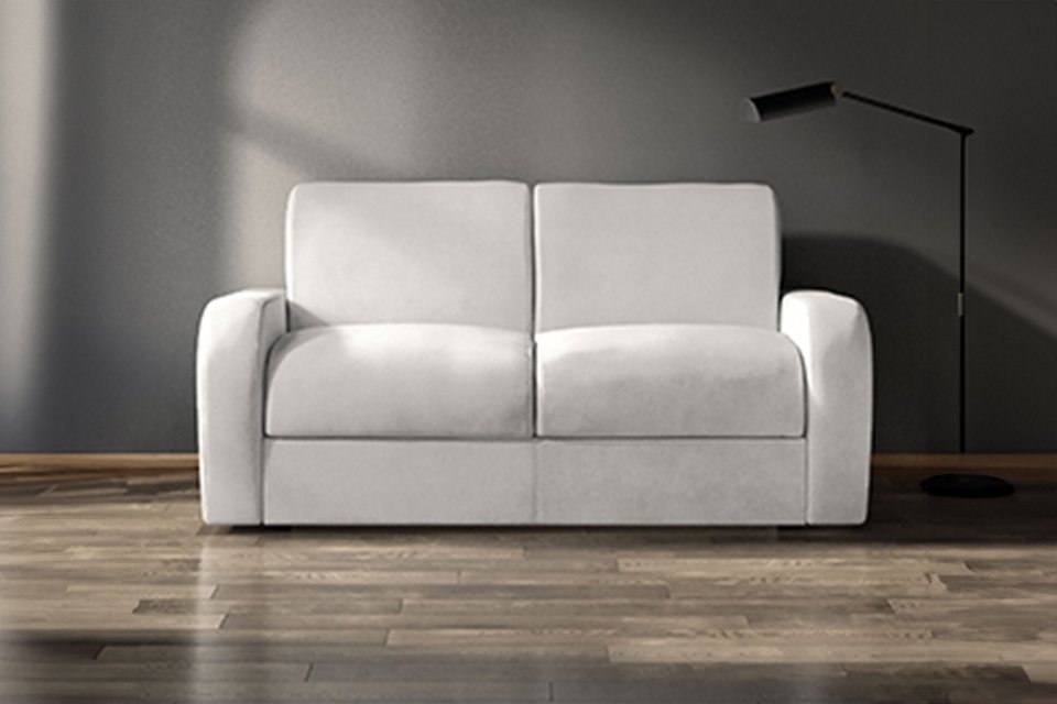 A white Jay-Be® Deco sofa bed in a living room setup. 