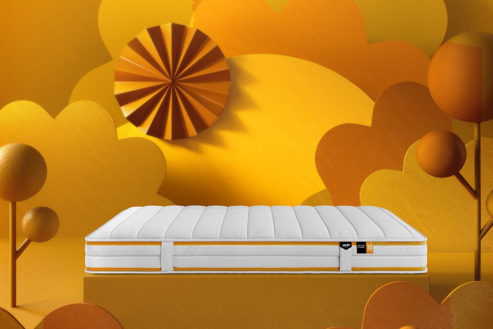 Jay-Be® Bio Fresh hybrid mattress against an orange animated background. 