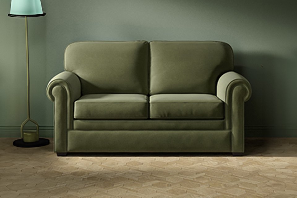An olive green Jay-Be® Heritage sofa bed in a living room setup. 