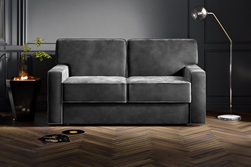 A grey Jay-Be® Linea sofa bed in a living room setup. 
