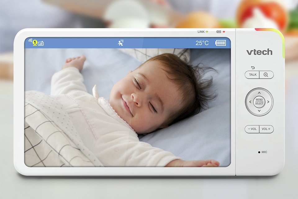 A parent watching a baby sleeping through the VTech VM7367HD 7 Inch Video Baby Monitor.