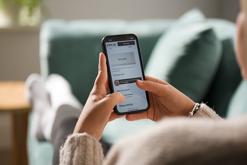 A person checking their Habitat app.