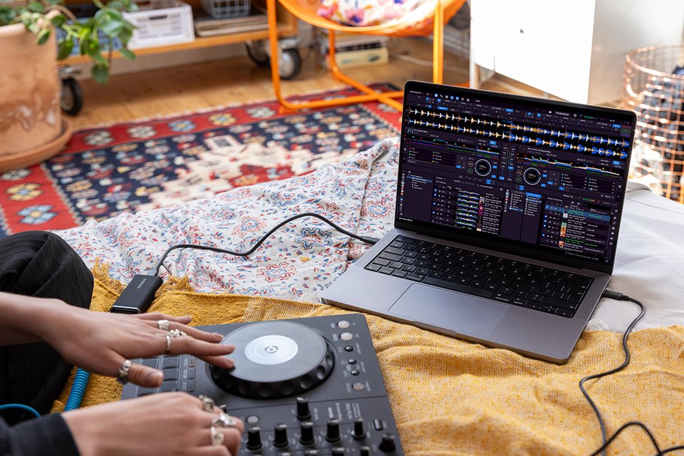 Someone using the rekordbox application on their laptop while Pioneer DJ controller is connected.