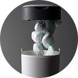 A person disposing nappies in a nappy bin.