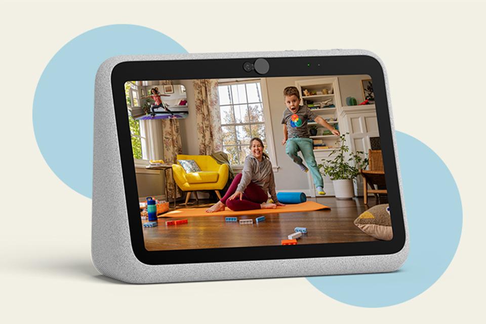 A woman sitting on a yoga mat and a toddler jumping high in the air are shown on the screen of a Portal video calling device.