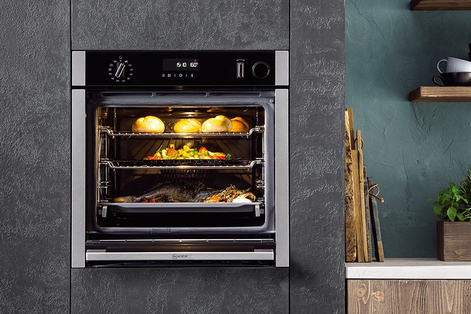 A NEFF single oven wall mounted on a grey wall. 