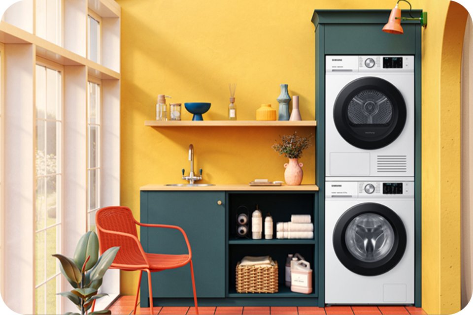  Samsung laundry machine and dryer placed in a yellow room.