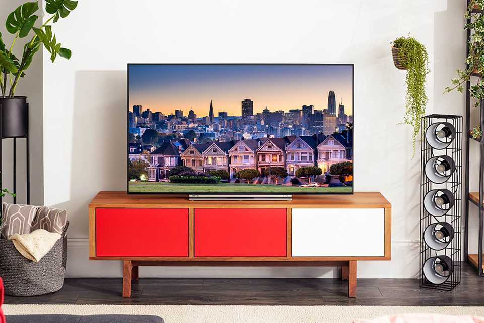 A TV sitting on a TV unit in a living room.