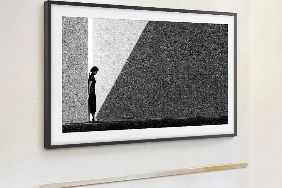TV displaying artwork on a wall.