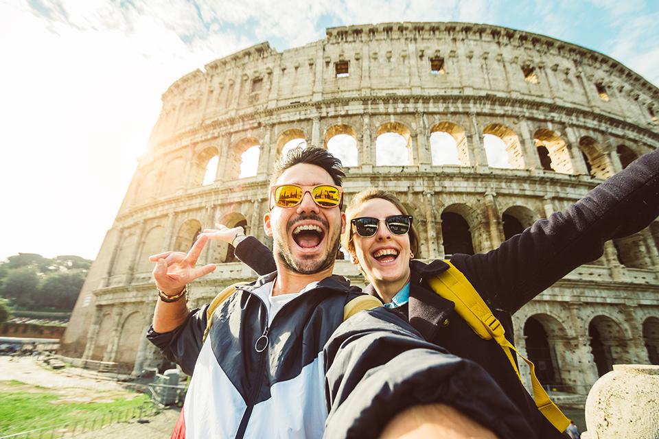 Couple taking a selfie outside Colosseum.